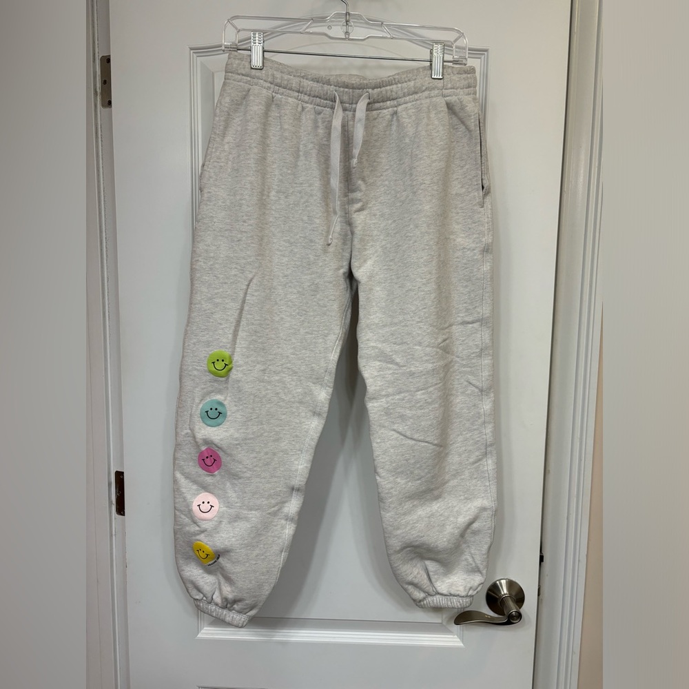 Gray sweatpants with multi color smileys